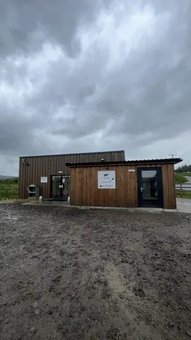 A wooden building with a sign on the door.