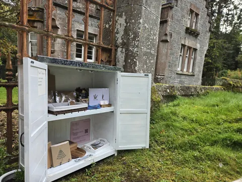 A white refrigerator with a pink sign on the door.
