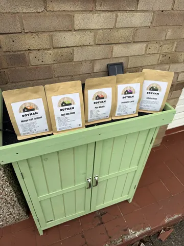 A green chest with bags of food in it.