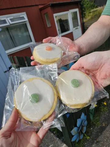 A person is holding a bag of cookies.