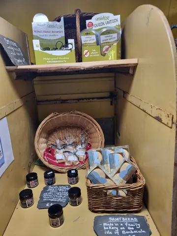 A basket of cookies is displayed on a yellow shelf.