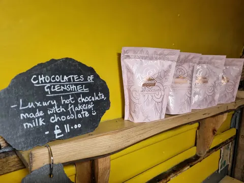 A chocolate display with a sign that says "Chocolates of Glen Shiel."
