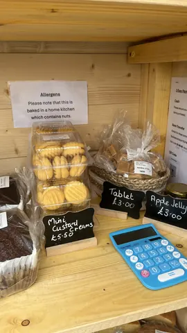 A table with a calculator on it and a sign that says "allergens".