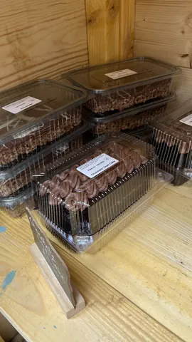 A stack of plastic containers filled with cake.