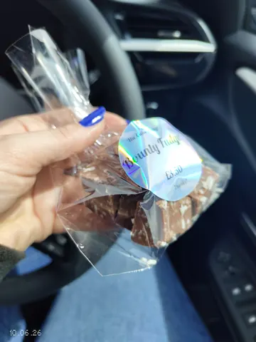 A person is holding a bag of chocolate.
