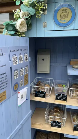 A blue and white sign with a QR code on it.
