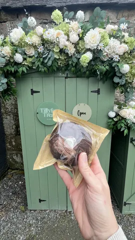 A person is holding a wrapped chocolate treat.