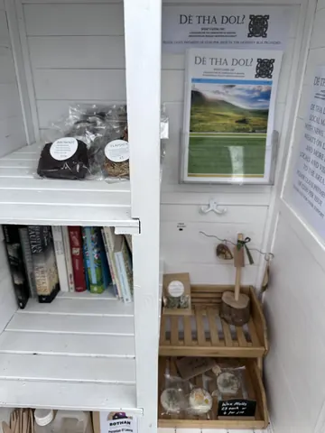 A white shelf with a sign on it.