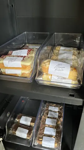 A display of cakes and pastries in a case.