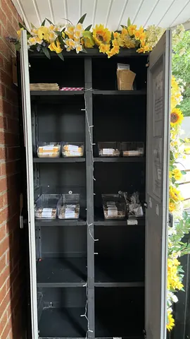 A black refrigerator with a shelf inside.
