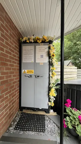 A brick wall with a sign and a small door.