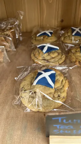 A bag of chocolate chip cookies with a blue and white flag on top.