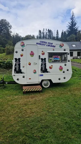 A white trailer with a dog on it.