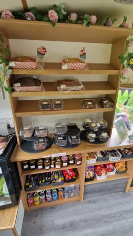 A shelf with a variety of food items on it.