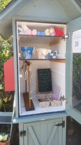 A small wooden shelf with a sign on it.