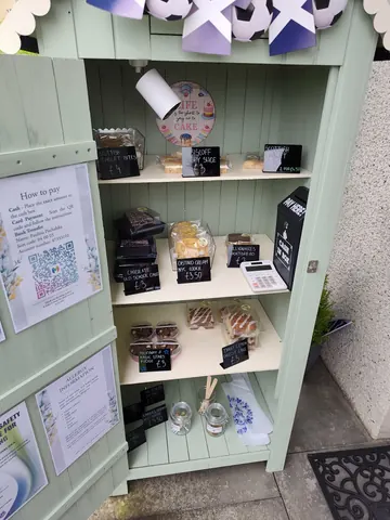 A green cabinet with a sign that says "how to pay".
