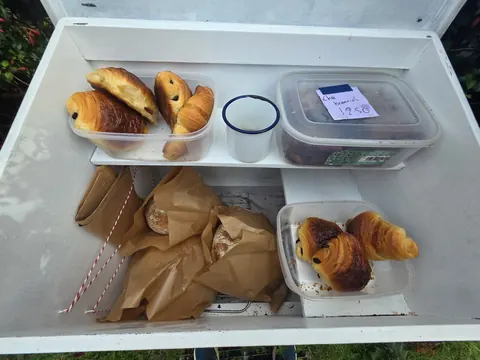 A refrigerator with a variety of food items inside.