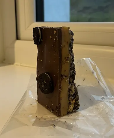 A chocolate bar with a black and white wrapper.