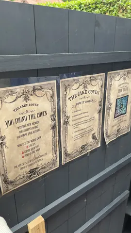 A sign that says "You Found the Coven" is posted on a wooden wall.