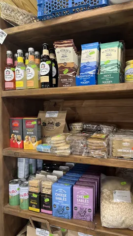 A shelf with a variety of food items on it.