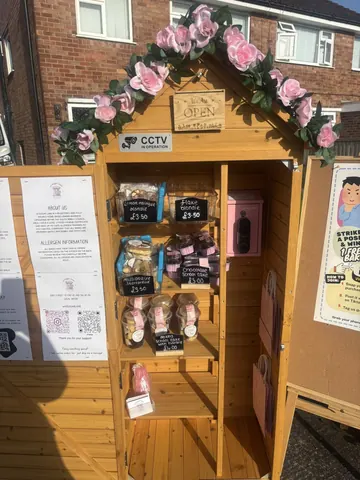 A small wooden structure with a sign that says "open" on it.