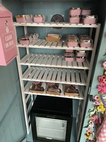 A refrigerator with a cash in a box sign on the door.