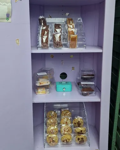 A purple shelf with a blue box on it.