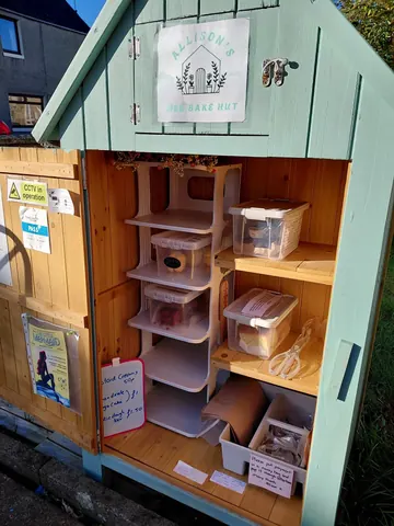 A small wooden structure with a sign on it.