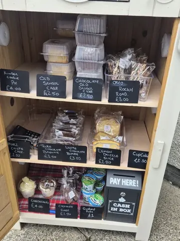 A wooden cabinet with a sign that says "Pay Here!"
