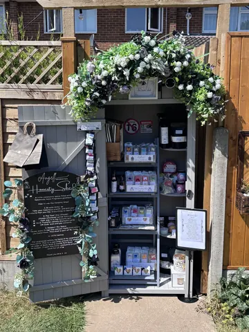 A small building with a sign on the door.