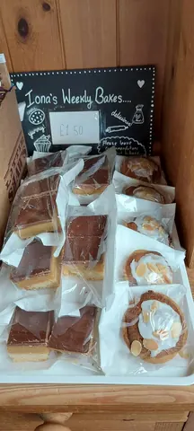A box of pastries with a sign that says "have a slice".