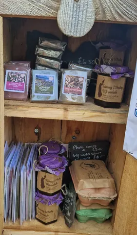 A wooden shelf with various items on it.