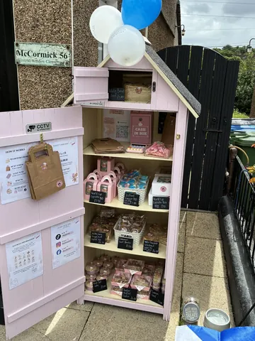 A pink building with a sign that says "Cake".