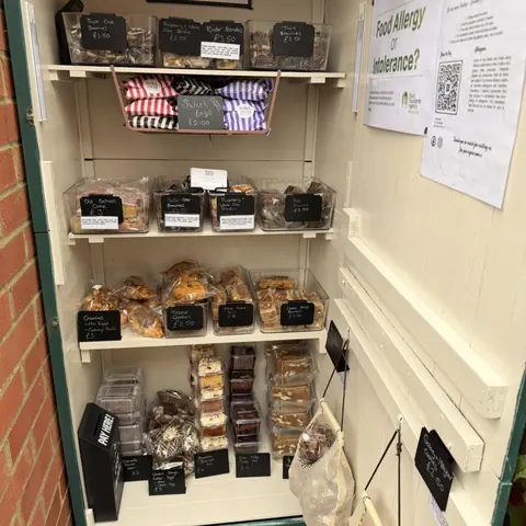 A display case with a variety of food items.