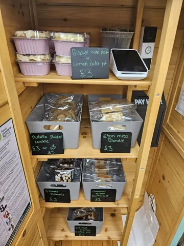 A wooden shelf with a variety of food items on it.