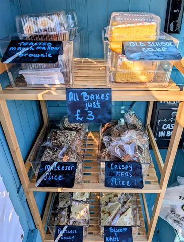 A display of various baked goods in a blue case.