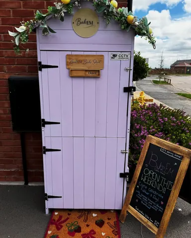 A purple door with a sign on it.