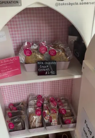 A shelf with cookies and other baked goods.