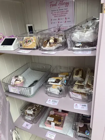 A shelf with a variety of food items on it.