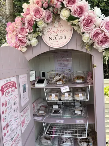 A pink and white display case with a sign that says "Baker's Box".