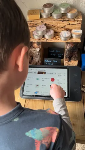 A young boy is using a tablet computer.