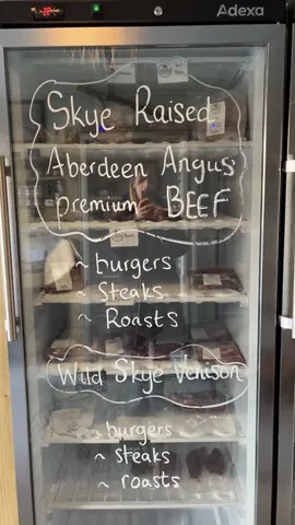 A refrigerator with a sign on it that says "wild skye venison".