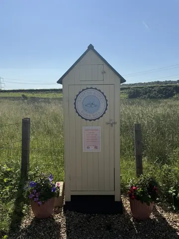 A wooden structure with a sign on it.