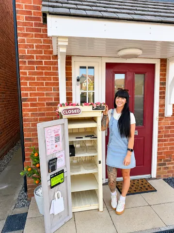A woman standing in front of a closed store.