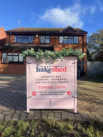 A sign is in front of a house that says "Bake Shed".