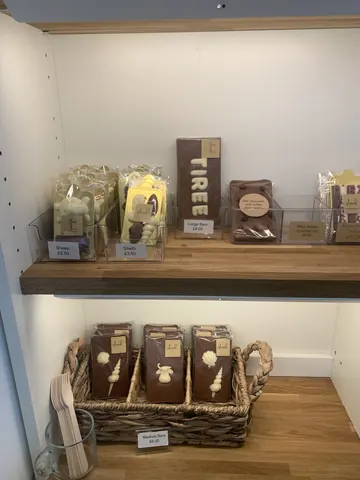 A shelf with a sign that says "Tiree" on it.
