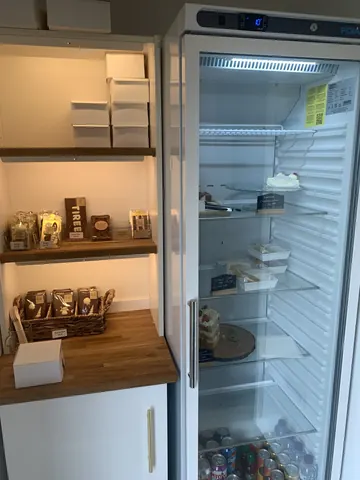 A refrigerator with a glass door and a shelf inside.