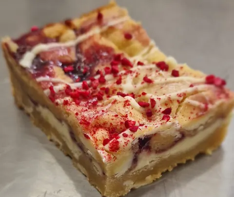 A piece of cake with red frosting on it.