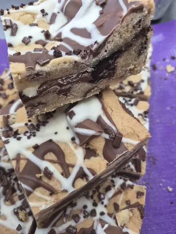 A piece of chocolate cake with white icing.