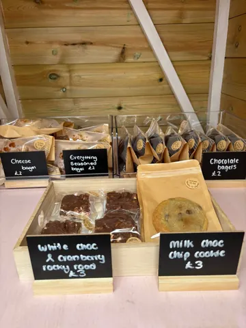A display of various food items, including cookies, cakes, and chocolates.